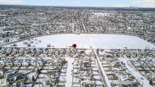 Aerial perspective showcasing a residential neighborhood with snow-covered rooftops and streets - 8477 Sloane Crescent, Edmonton, AB - Outdoor With View