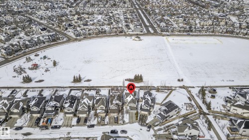 Residential neighborhood featuring detached homes with varied architectural styles and front-facing garages - 8477 Sloane Crescent, Edmonton, AB - Outdoor With View