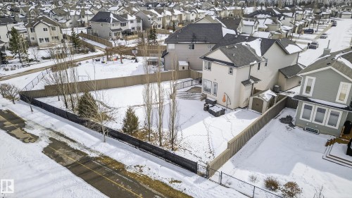 Spacious backyard featuring an extensive lawn area, a privacy fence, and mature trees - 8477 Sloane Crescent, Edmonton, AB - Outdoor