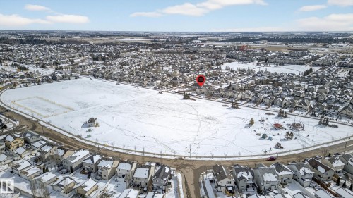 Expansive aerial perspective showcasing a residential neighborhood with numerous homes featuring snow-covered rooftops - 8477 Sloane Crescent, Edmonton, AB - Outdoor With View