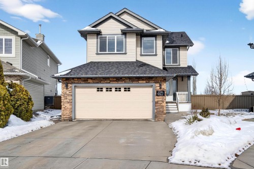 Two-story residence featuring a neutral siding exterior with stone accents - 8477 Sloane Crescent, Edmonton, AB - Outdoor