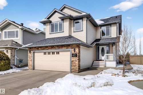 Two-story residence featuring light-colored horizontal siding and dark trim accents - 8477 Sloane Crescent, Edmonton, AB - Outdoor With Facade