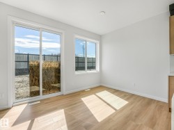 Bright interior space featuring wood-finish flooring and white walls - 