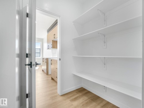 Pantry featuring multiple white shelving units for organized storage - 272 Munn Way, Leduc, AB - Indoor With Storage