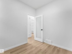 Room featuring light wood-finish flooring, white walls, and white trim - 