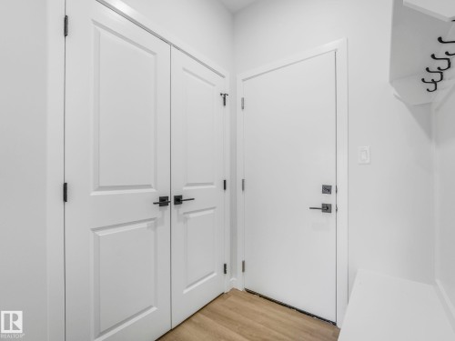Entryway featuring white paneled doors with matte black hardware - 272 Munn Way, Leduc, AB - Indoor Photo Showing Other Room