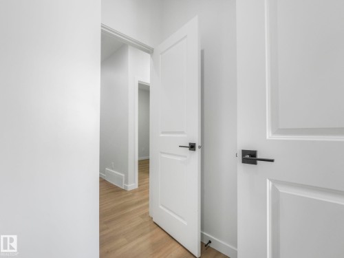 Contemporary interior doors with matte black hardware - 272 Munn Way, Leduc, AB - Indoor Photo Showing Other Room