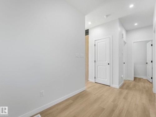 Corridor with light wood-finish flooring, white baseboards, and recessed ceiling lighting - 272 Munn Way, Leduc, AB - Indoor Photo Showing Other Room