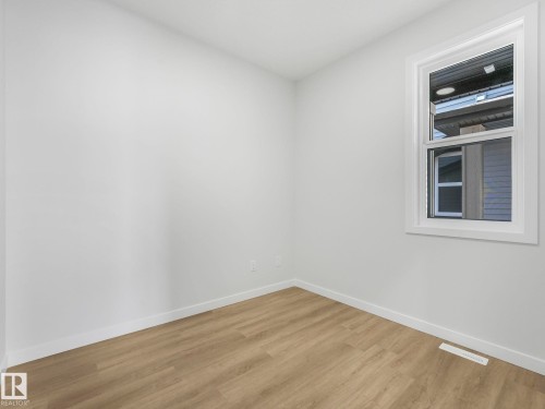 Room featuring light wood-finish flooring, white walls, and a single window with white trim - 272 Munn Way, Leduc, AB - Indoor Photo Showing Other Room