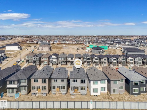 Contemporary two-story residence featuring a neutral-toned facade and multiple windows - 272 Munn Way, Leduc, AB - Outdoor With View