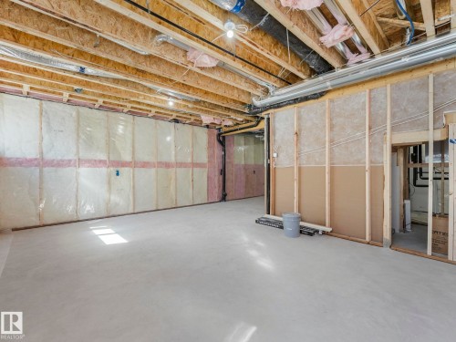 Unfinished basement with exposed wood joists and subflooring, insulated walls, and concrete flooring - 272 Munn Way, Leduc, AB - Indoor Photo Showing Basement