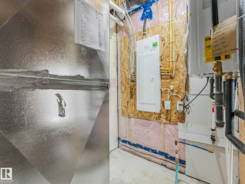 Utility area featuring a water heater, electrical panel, and exposed ductwork - 272 Munn Way, Leduc, AB - Indoor Photo Showing Basement