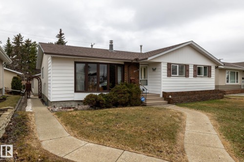 Single-story residence featuring white horizontal siding and a brown shingle roof - 8612 68A Street, Edmonton, AB - Outdoor
