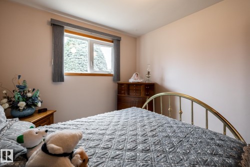 Bright room featuring a window with vertical blinds, light-toned walls, and white trim - 8612 68A Street, Edmonton, AB - Indoor Photo Showing Bedroom