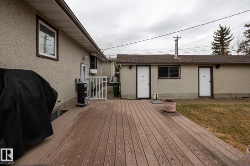 Expansive outdoor deck featuring wood-finish composite decking and white railing - 8612 68A Street, Edmonton, AB - Outdoor With Deck Patio Veranda With Exterior
