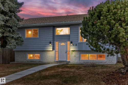 Split-level residence featuring light blue horizontal siding and a white brick-style foundation - 2039 48 Street, Edmonton, AB - Outdoor