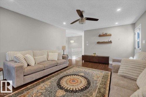 Living room featuring a textured ceiling, dark wood finished floors, recessed lighting, and a ceiling fan - 3515 20 Avenue, Edmonton, AB - Indoor Photo Showing Living Room