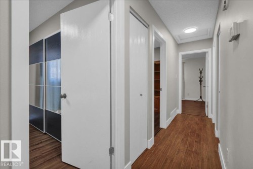 Hallway with dark wood-type flooring and a textured ceiling - 3515 20 Avenue, Edmonton, AB - Indoor Photo Showing Other Room