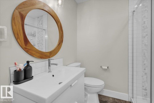Full bathroom featuring vanity, a shower stall, and tasteful backsplash - 3515 20 Avenue, Edmonton, AB - Indoor Photo Showing Bathroom