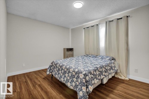 Bedroom featuring a textured ceiling and wood finished floors - 3515 20 Avenue, Edmonton, AB - Indoor Photo Showing Bedroom