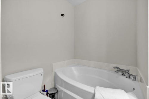 Bathroom with a garden tub and toilet - 3515 20 Avenue, Edmonton, AB - Indoor Photo Showing Bathroom