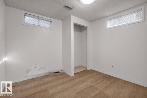 Unfurnished bedroom with a textured ceiling and carpet floors - 3515 20 Avenue, Edmonton, AB - Indoor