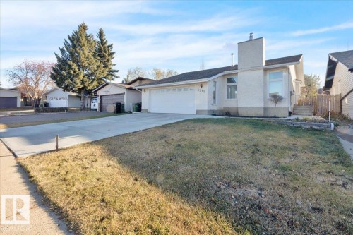 Single story home with concrete driveway, a chimney, a front lawn, and an attached garage - 3515 20 Avenue, Edmonton, AB - Outdoor