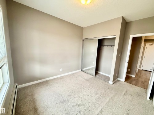 Bedroom featuring neutral-toned walls and light-colored carpeting - 437 5504 Schonsee Drive, Edmonton, AB - Indoor Photo Showing Other Room