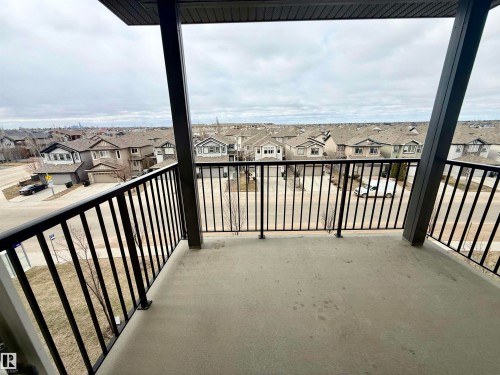 Concrete balcony with black metal railings and overhead soffit - 437 5504 Schonsee Drive, Edmonton, AB - Outdoor With Balcony With Exterior