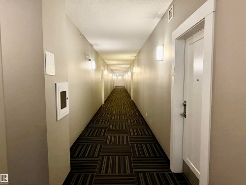 Corridor featuring a patterned carpet, neutral wall tones, and recessed lighting - 437 5504 Schonsee Drive, Edmonton, AB - Indoor Photo Showing Other Room