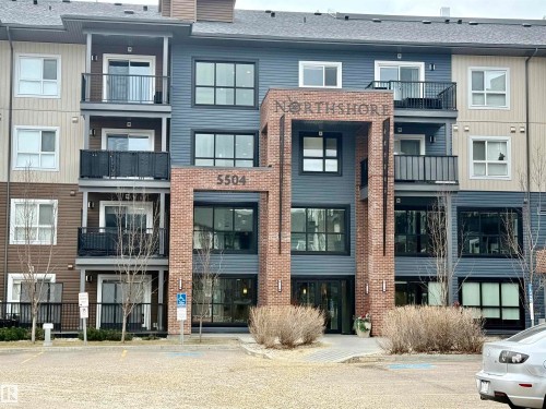 Multi-story condominium building featuring a brick and siding exterior with a prominent main entrance - 437 5504 Schonsee Drive, Edmonton, AB - Outdoor With Balcony With Facade