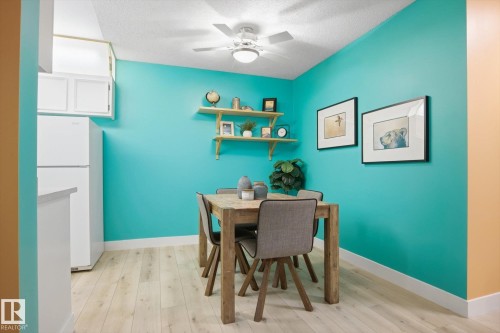 Open dining area featuring wood-finish flooring and a ceiling fan with integrated lighting - 103 10732 86 Avenue, Edmonton, AB - Indoor Photo Showing Dining Room