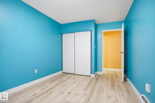 Room featuring light wood-finish flooring, white baseboards, and a neutral ceiling - 103 10732 86 Avenue, Edmonton, AB - Indoor Photo Showing Other Room