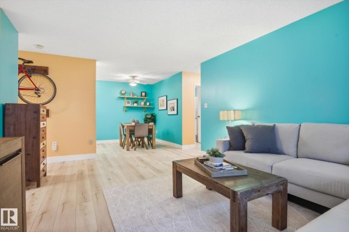 Open-concept living area with light wood-finish flooring - 103 10732 86 Avenue, Edmonton, AB - Indoor Photo Showing Living Room