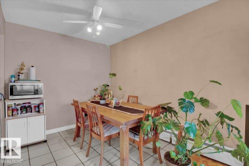 The property features a dining area with tiled flooring and a ceiling fan with integrated lighting - 412 2908 116A Avenue, Edmonton, AB - Indoor Photo Showing Dining Room