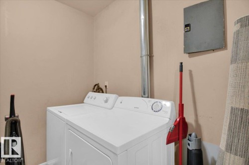 The property features a dedicated laundry area with a white top-loading washing machine and a white front-loading dryer - 412 2908 116A Avenue, Edmonton, AB - Indoor Photo Showing Laundry Room