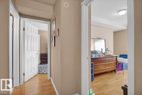 Hallway with light hardwood flooring and neutral-toned walls - 412 2908 116A Avenue, Edmonton, AB - Indoor Photo Showing Other Room