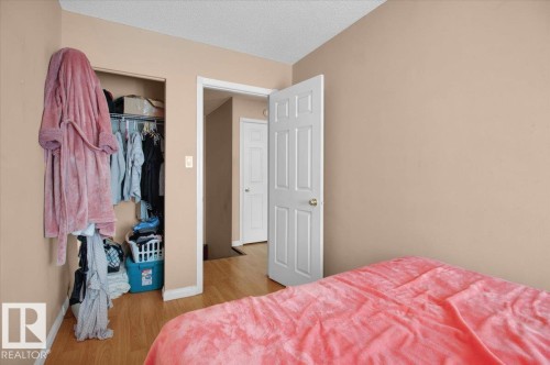 The property features light-colored walls and wood-look flooring - 412 2908 116A Avenue, Edmonton, AB - Indoor Photo Showing Bedroom