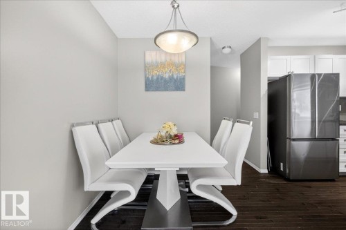 Dining area featuring baseboards and dark wood-style floors - 47 230 Edwards Drive, Edmonton, AB - Indoor Photo Showing Dining Room