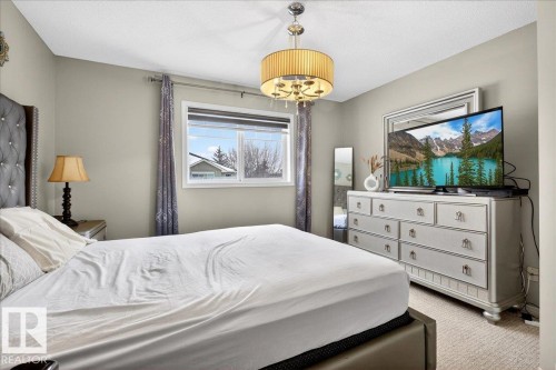 Carpeted bedroom featuring a textured ceiling - 47 230 Edwards Drive, Edmonton, AB - Indoor Photo Showing Bedroom