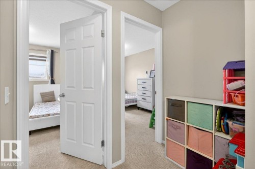 Carpeted bedroom with a textured ceiling - 47 230 Edwards Drive, Edmonton, AB - Indoor