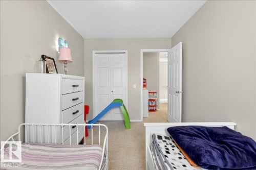 Bedroom featuring light carpet and a closet - 47 230 Edwards Drive, Edmonton, AB - Indoor Photo Showing Bedroom