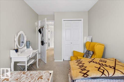 Bedroom with a closet and light colored carpet - 47 230 Edwards Drive, Edmonton, AB - Indoor Photo Showing Bedroom
