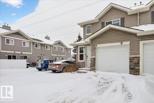 Traditional-style home with a garage and stone siding - 47 230 Edwards Drive, Edmonton, AB - Outdoor