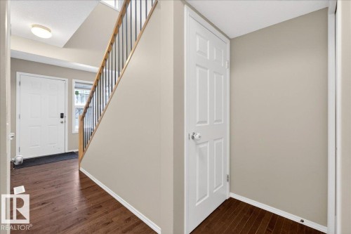 Foyer featuring stairway and dark wood-type flooring - 47 230 Edwards Drive, Edmonton, AB - Indoor Photo Showing Other Room
