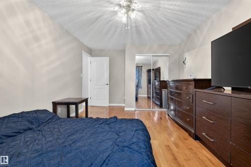 Bedroom featuring wood-finish flooring, a ceiling fan with integrated lighting, and neutral wall tones - 17120 103 Street, Edmonton, AB - Indoor Photo Showing Bedroom