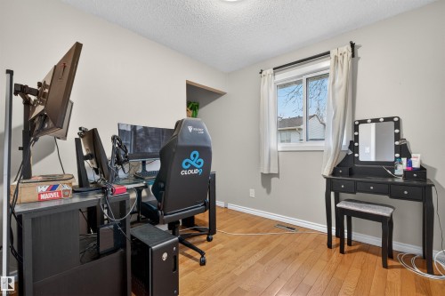 Room featuring wood-finish flooring, neutral wall paint, and a textured ceiling - 17120 103 Street, Edmonton, AB - Indoor