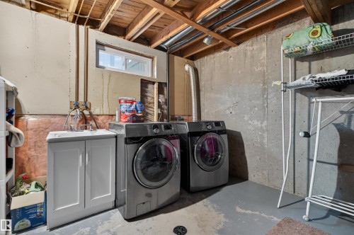 Dedicated laundry area featuring a utility sink with a white cabinet base - 17120 103 Street, Edmonton, AB - Indoor Photo Showing Laundry Room