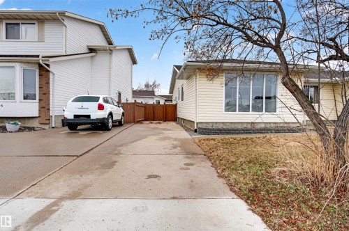 Light beige siding exterior with a large front picture window and a concrete driveway - 17120 103 Street, Edmonton, AB - Outdoor
