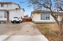 Light beige siding exterior with a large front picture window and a concrete driveway - 17120 103 Street, Edmonton, AB  - Outdoor 